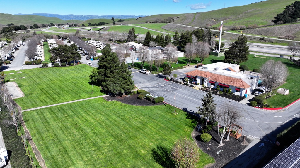 an aerial view of Betabel featuring open grassy pace and scenic hills